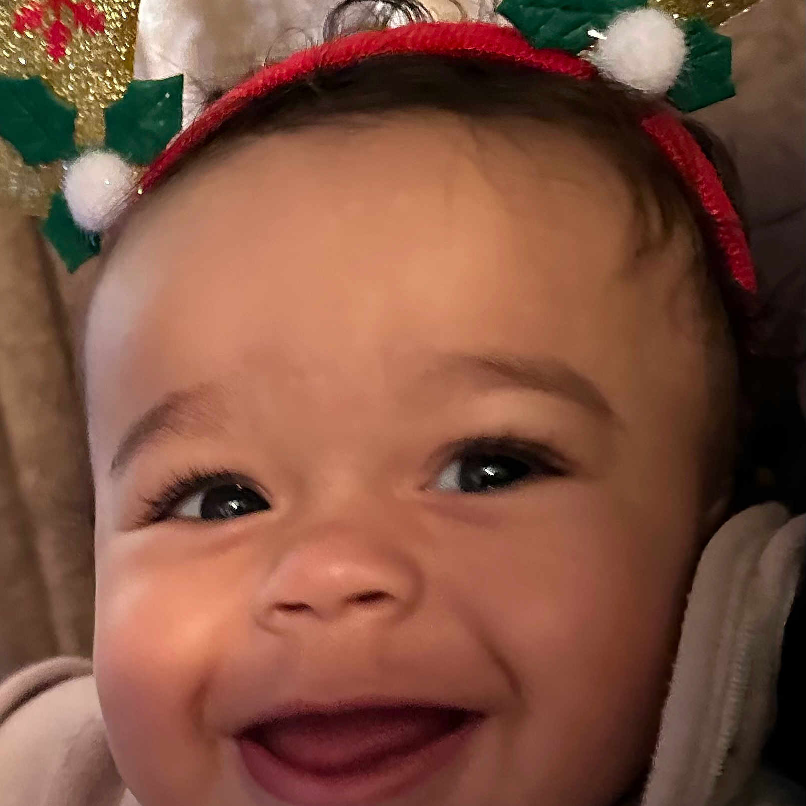 Cordell is registered to the contest to win money with this photo: apparel, baby, child, christmas, closeup, costume, cute, expression, face, festive, happy, headband, holiday, holly, indoors, infant, person, portrait, reindeer_antlers, smiling