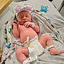 Octavia is registered to the contest to win money with this photo: newborn, baby, infant, hat, bow, diaper, blanket, hospital, wristband, pacifier, sleeping, cute, resting, child, human, skin, foot, hand, bed, person