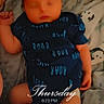 baby, sleeping, onesie, blue_clothing, blanket, soft_texture, infant, lying_down, cozy, timestamp, text_overlay, child, cute, newborn, peaceful, indoors, fabric, sock, portrait, resting