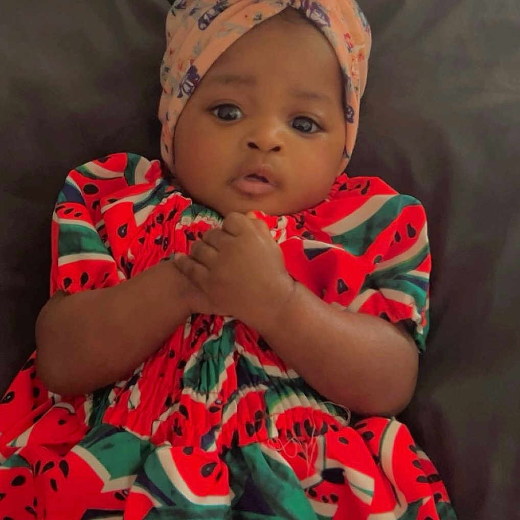 Loryn joined the competition — help win amazing prizes! baby, blanket, bonnet, cap, clothing, couch, dress, face, flower, furniture, happy, hat, head, person, photography, portrait, quilt, scarf, sitting, smile