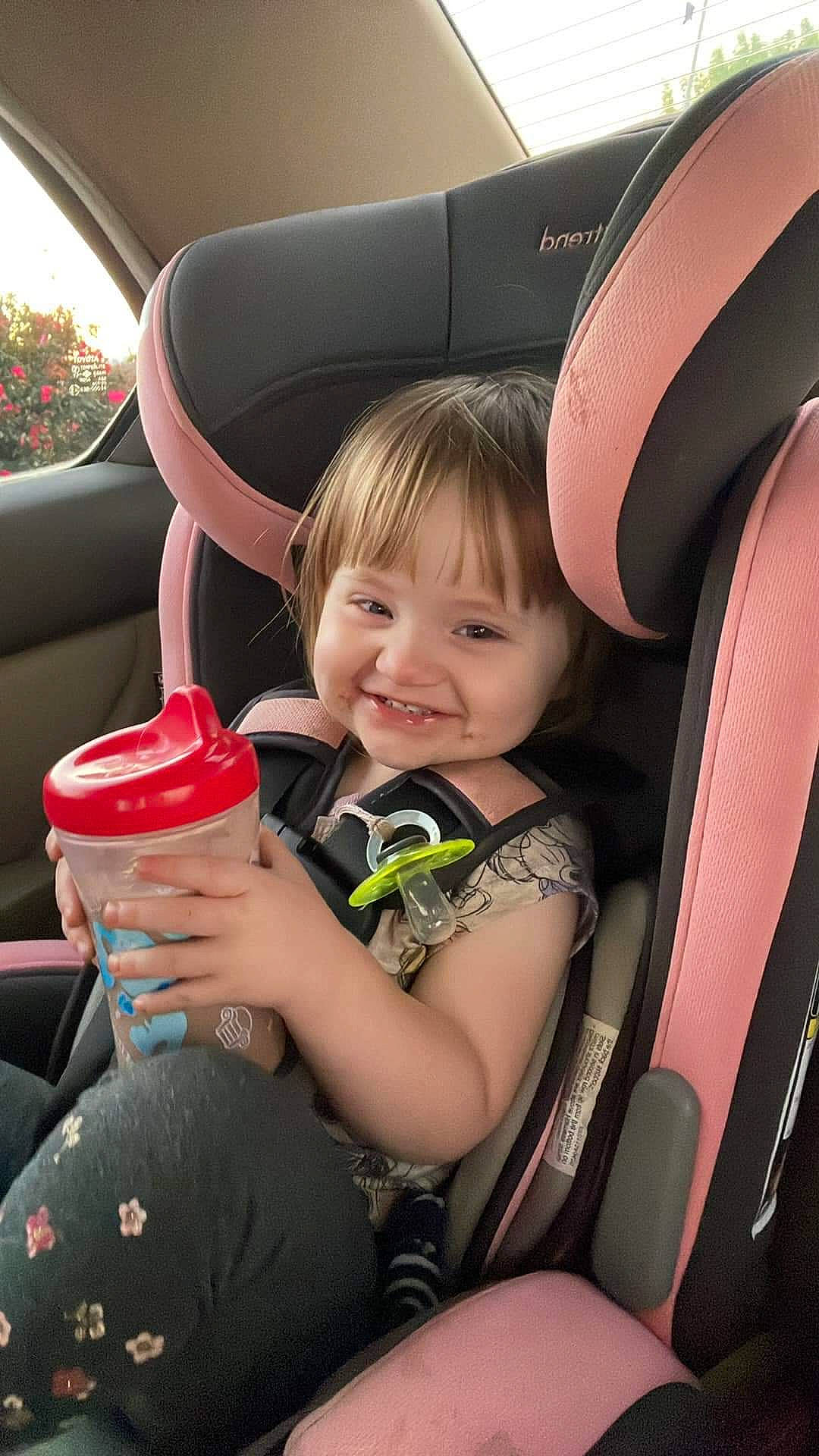 Jolene is registered to the contest to win money with this photo: auto_part, automotive_design, automotive_exterior, car_seat, car_seat_cover, child, comfort, family_car, fun, happy, joy, leisure, luxury_vehicle, motor_vehicle, person, plant, sitting, skin, smile, steering_wheel