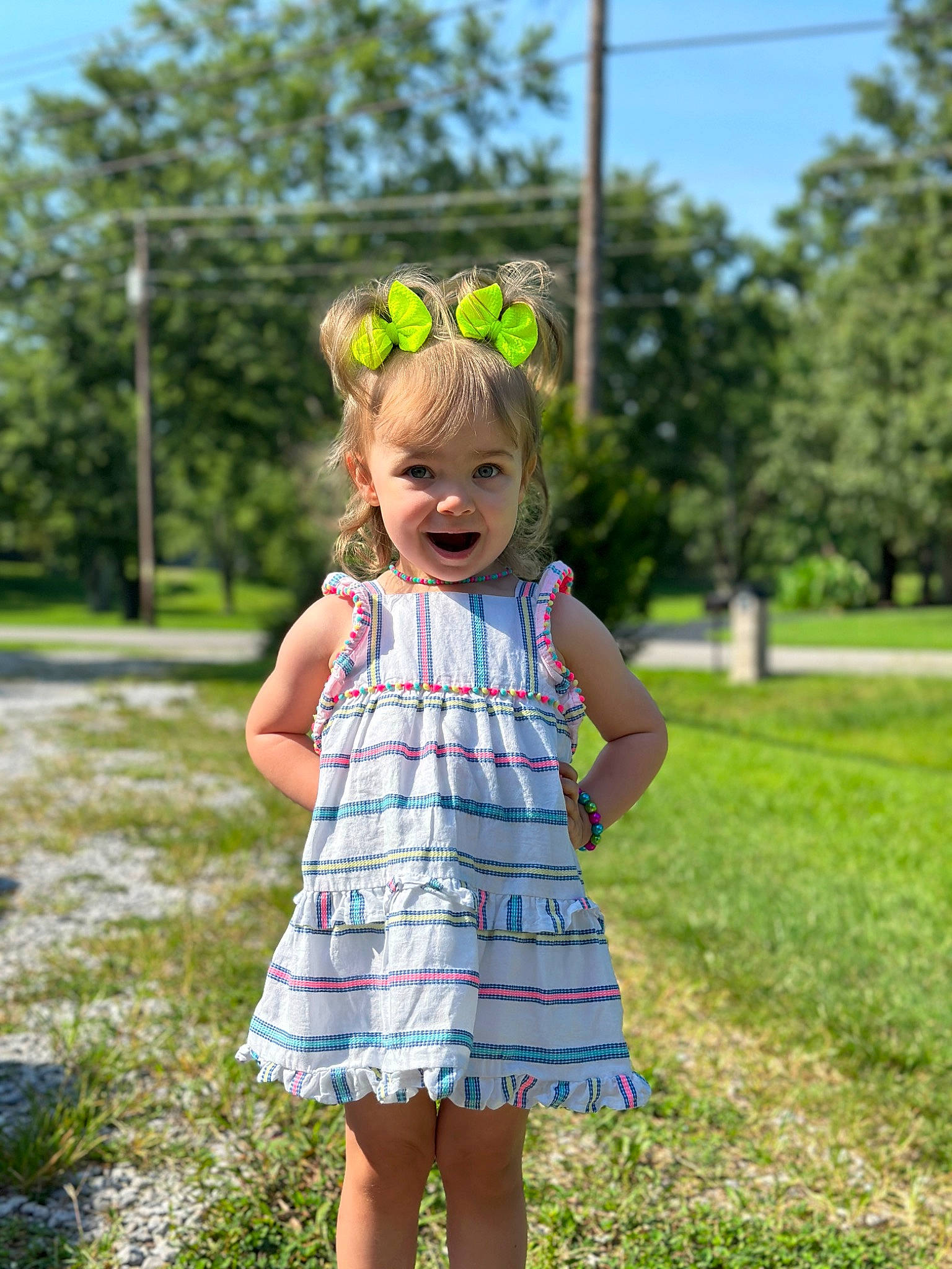 Shayleigh joined the competition — help win amazing prizes! baby_toddler_clothing, botany, clothing, dress, facial_expression, grass, hair, hairstyle, happy, leaf, one_piece_garment, people_in_nature, person, pink, plant, sky, smile, standing, sunlight, toddler