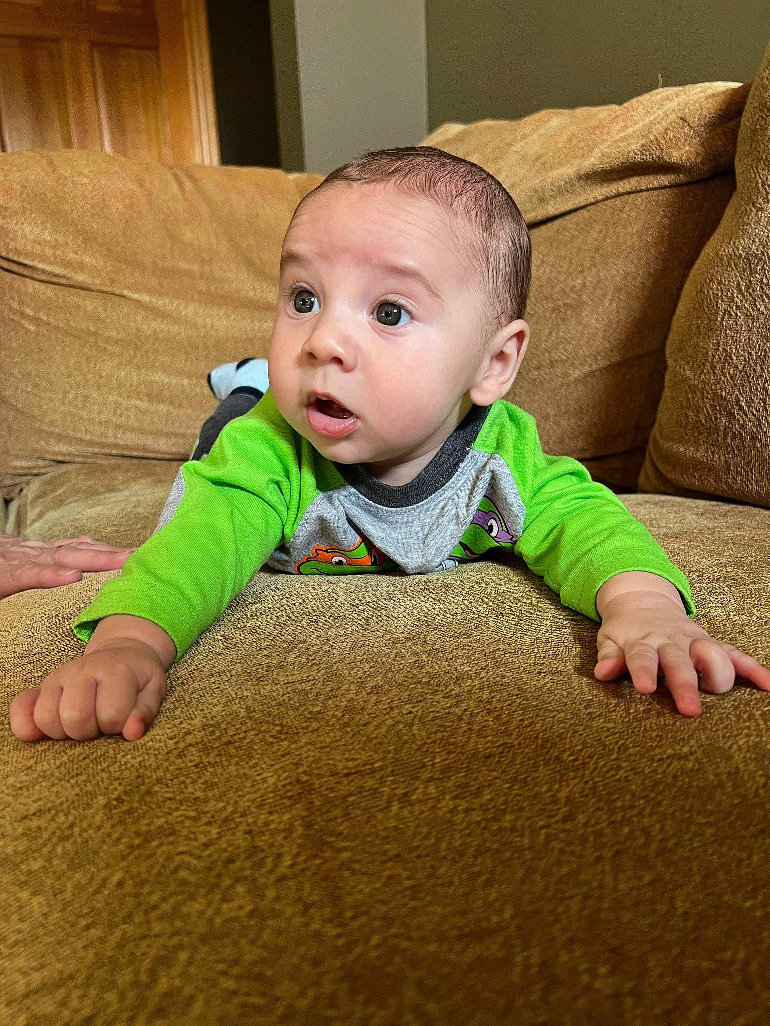 Koltyn is registered to the contest to win money with this photo: baby, baby_toddler_clothing, brown, cheek, child, comfort, crawling, eye, facial_expression, floor, flooring, fun, grass, hardwood, head, nose, person, skin, sleeve, surprise