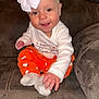 baby, child, smiling, headband, bow, orange_pants, ghost_prints, socks, couch, furniture, happy, cute, indoor, person, infant, sitting, clothing, portrait, hand, cozy