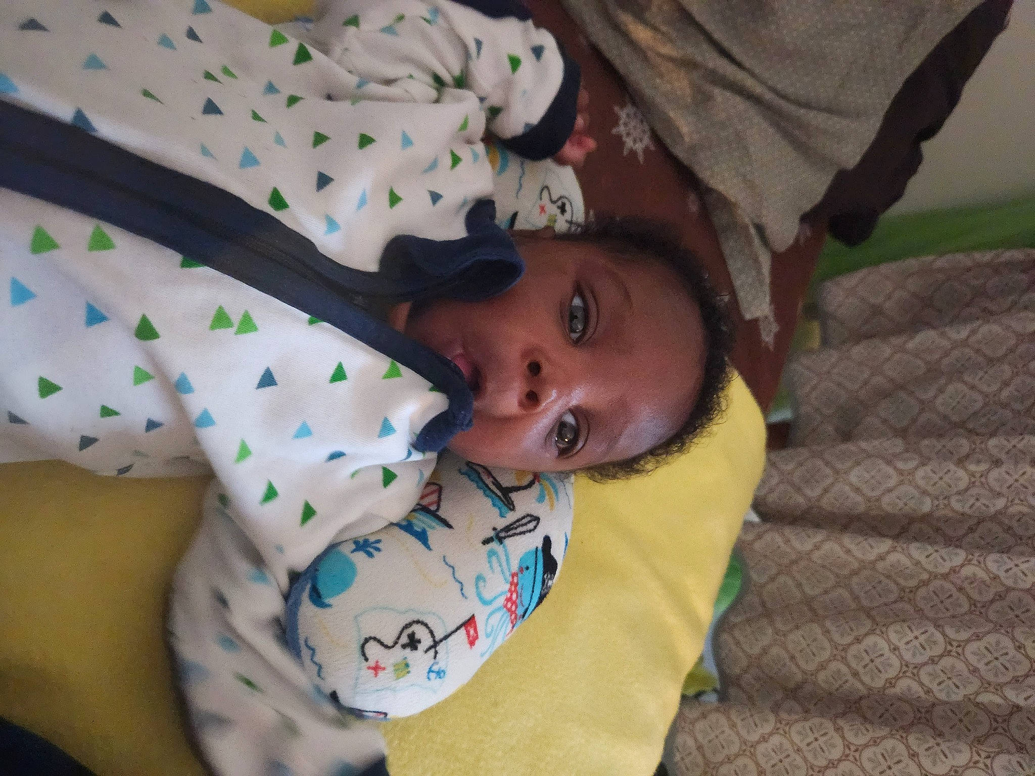 Wisdom is registered to the contest to win money with this photo: arm, baby, baby_toddler_clothing, child, comfort, elbow, fun, grass, happy, head, linens, mouth, pattern, person, sitting, skin, sleeve, toddler, tree