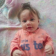 Sofia joined the competition — help win amazing prizes! baby, child, onesie, pink_clothing, blanket, toddler, face, hands, lying_down, indoor, cute, infant, smiling, soft_texture, pastel_colors, hair, expression, young_child, person, sleepwear