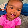 toddler, child, smiling, baby, pink_shirt, hair_puffs, hand, holding_hands, indoor, carpet, sofa, portrait, cute, happy, person, skin, face, young_child, seated, closeup