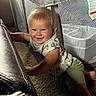 Holden joined the competition — help win amazing prizes! toddler, child, baby, crawling, carpet, couch, leather, playpen, indoor, smiling, happy, blond_hair, short_sleeves, green_pants, fabric, home, furniture, person, cute, young_child