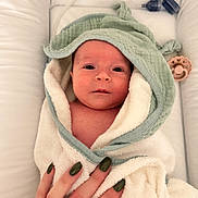 Adaé participe au concours pour gagner de l'argent avec cette photo : baby, infant, towel, hooded_towel, hand, nails, green_nail_polish, white, soft, cushion, bed, newborn, wrapped, skin, cute, portrait, indoor, cozy, looking, person