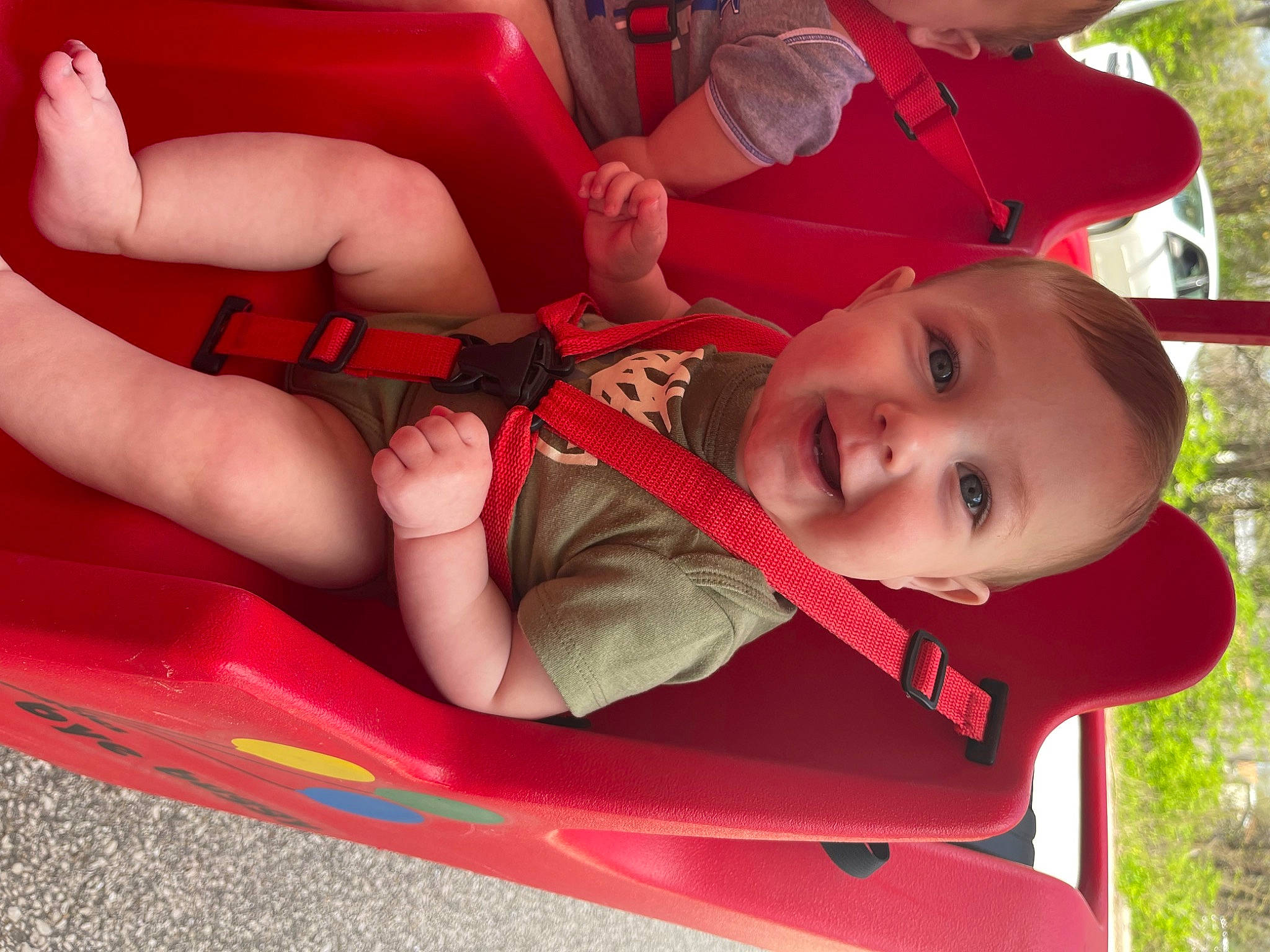 Colsyn joined the competition — help win amazing prizes! automotive_exterior, baby, baby_toddler_clothing, bumper, child, fun, grass, happy, human_body, joy, knee, leisure, mouth, person, plant, product, recreation, red, smile, thigh