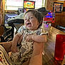 Emry joined the competition — help win amazing prizes! baby, child, smiling, indoor, person, clothing, arm, table, red_cup, wood, restaurant, pub, light, window, chair, pattern, elephant, holding, happy, casual