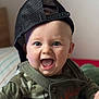 baby, child, smiling, face, cap, hat, clothing, camouflage, indoor, portrait, happy, cute, person, sitting, expression, young_child, headwear, mouth_open, eyes, baby_clothes