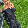 Willow a rejoint le concours — aidez-le/la à gagner de superbes lots ! child, girl, black_dress, grass, outdoor, car, parked_car, greenery, smile, fashion, posing, young, happy, person, nature, casual, daylight, cute, dress, portrait