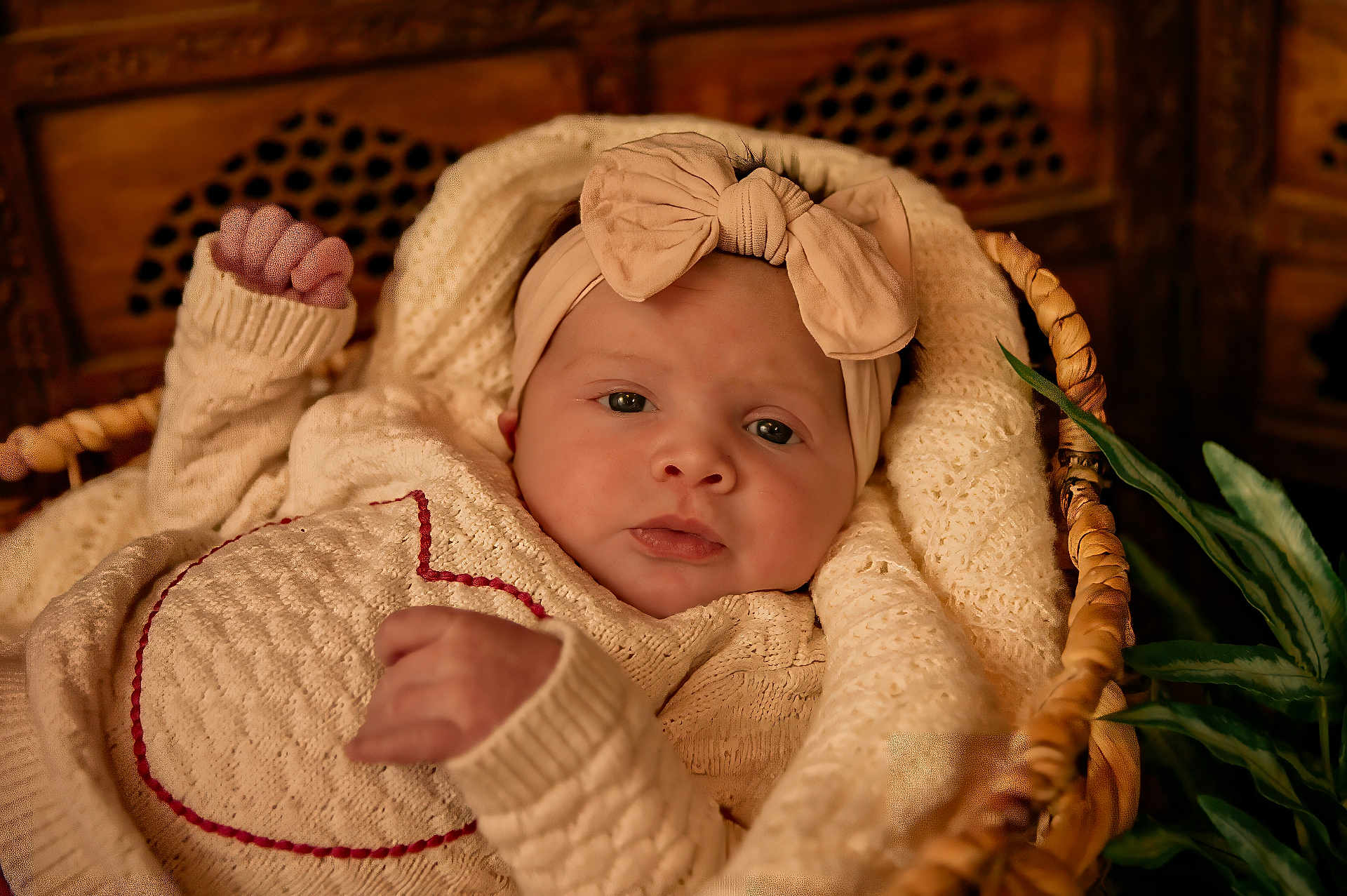 Kennedy joined the competition — help win amazing prizes! baby, infant, headband, bow, knitwear, blanket, basket, woven, cozy, cute, portrait, indoors, soft_lighting, closeup, child, warm_colors, texture, hand, face, expression