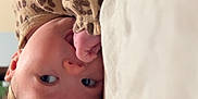 Blakely joined the competition — help win amazing prizes! baby, infant, child, bow_headband, leopard_print, pajamas, blanket, bed, lying_down, thumb_sucking, close_up, portrait, hand, face, eyes, cute, indoor, soft_lighting, fabric, cozy