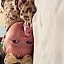 baby, infant, child, bow_headband, leopard_print, pajamas, blanket, bed, lying_down, thumb_sucking, close_up, portrait, hand, face, eyes, cute, indoor, soft_lighting, fabric, cozy