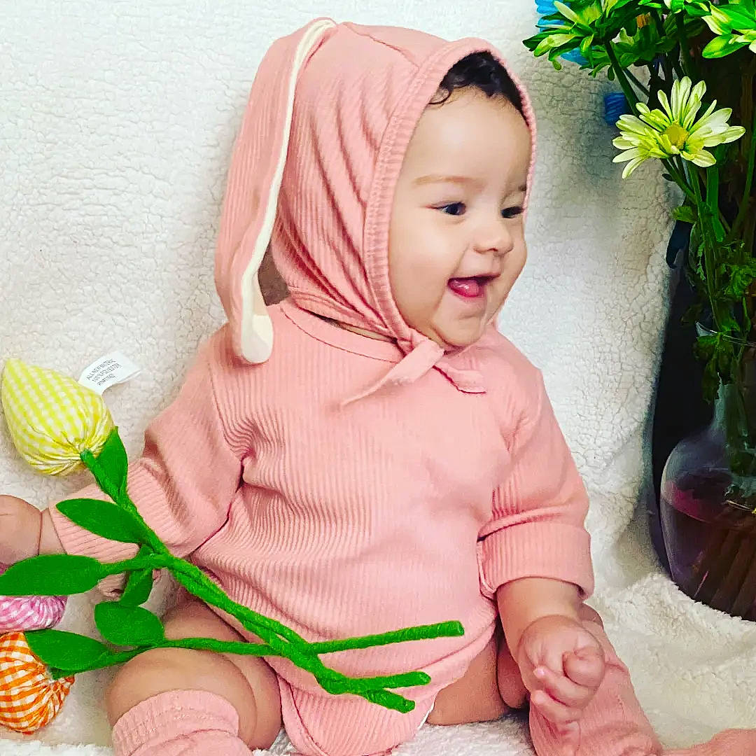 Ruth joined the competition — help win amazing prizes! baby, baby_toddler_clothing, child, flower, flowerpot, grass, green, happy, houseplant, people_in_nature, person, petal, pink, plant, product, skin, sleeve, smile, thigh, thumb