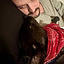 Frank is registered to the contest to win money with this photo: affection, beard, bond, casual_clothing, close_up, comfort, cuddle, dark_hair, dog, face, friendship, head, indoor, love, lying_down, man, pet, portrait, red_bandana, relaxation