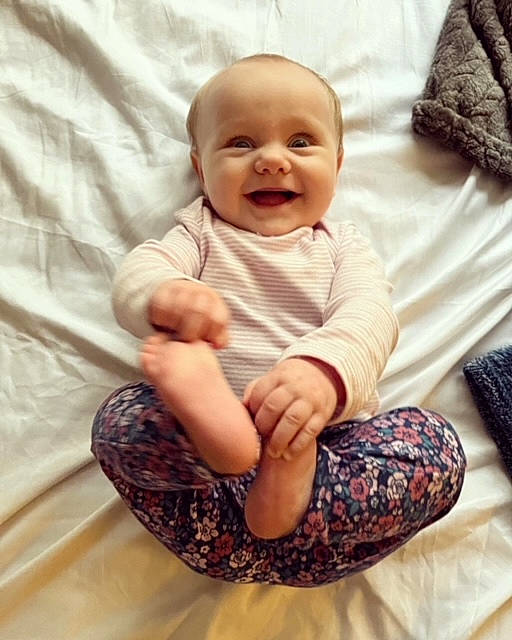 Alexis is registered to the contest to win money with this photo: arm, baby, baby_toddler_clothing, comfort, eye, finger, gesture, hairstyle, happy, head, human_body, leg, person, product, skin, sleeve, smile, standing, textile, toddler