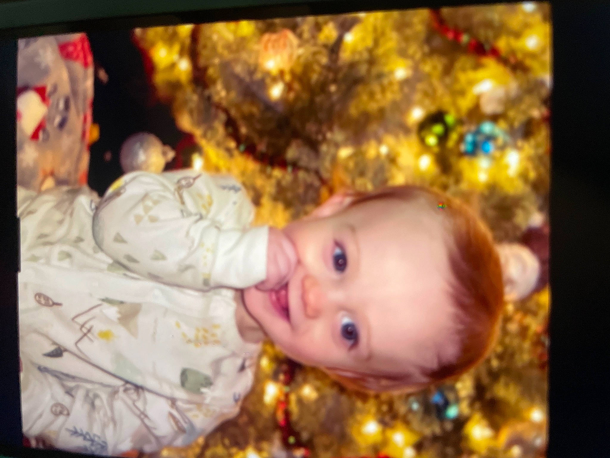 Hunter is registered to the contest to win money with this photo: baby, baby_toddler_clothing, beauty, cheek, child, christmas, christmas_decoration, christmas_eve, christmas_ornament, christmas_tree, display_device, event, eye, fun, happy, holiday, joy, lighting, ornament, person
