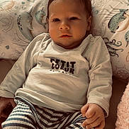 Mayann a rejoint le concours — aidez-le/la à gagner de superbes lots ! baby, infant, child, pillow, bedding, onesie, striped_pants, sock, hand, face, eyes, hair, portrait, soft_lighting, indoors, cute, cozy, nautical_pattern, sleepy, cuddly