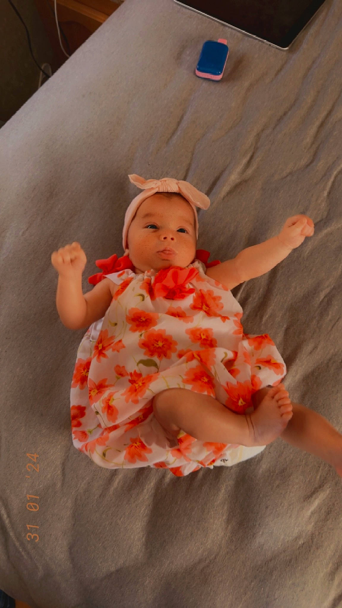 Ivory is registered to the contest to win money with this photo: baby, baby_toddler_clothing, baby_toys, cheek, child, day_dress, doll, dress, fashion_accessory, happy, orange, pattern, peach, person, pink, ruffle, sitting, sleeve, textile, toddler
