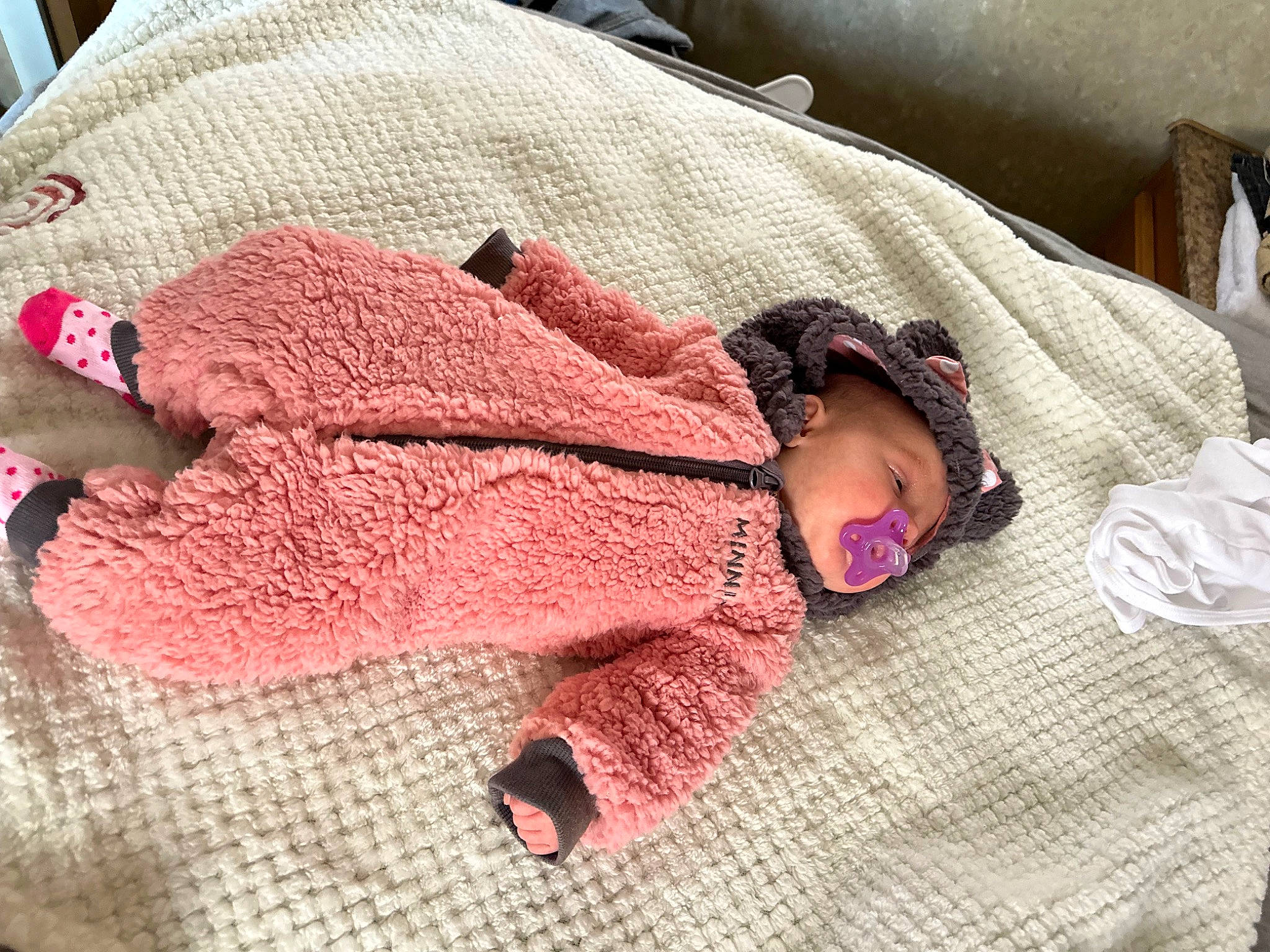 Ivory is registered to the contest to win money with this photo: baby, baby_toddler_clothing, child, comfort, craft, creative_arts, finger, flooring, hand, linens, magenta, pattern, person, pink, sleeve, textile, thread, toddler, wood, wool