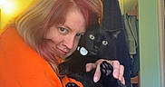 Pepsi Gerald joined the competition — help win amazing prizes! affection, animal, black_cat, casual, cat, cozy, curious, cute, feline, home, hugging, indoor, light, orange_sweater, person, pet, portrait, towels, wall, wide_eyes