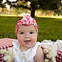 Charlotte is registered to the contest to win money with this photo: baby, child, smiling, headband, white_dress, basket, red_and_white, checkered_pattern, outdoor, grass, flowers, greenery, cute, portrait, happy, infant, nature, sunlight, tree, closeup