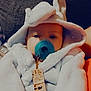 baby, pacifier, hooded_robe, white_clothing, infant, face, blue_pacifier, clip, patterned_clip, hand, cozy, soft_texture, closeup, indoor, resting, cute, child, person, blanket, warm