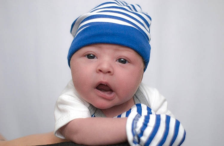 Anthony Jr is registered to the contest to win money with this photo: baby, beanie, blue, bonnet, cap, child, fashion_accessory, headgear, headwear, knit_cap, person, surprise, toddler