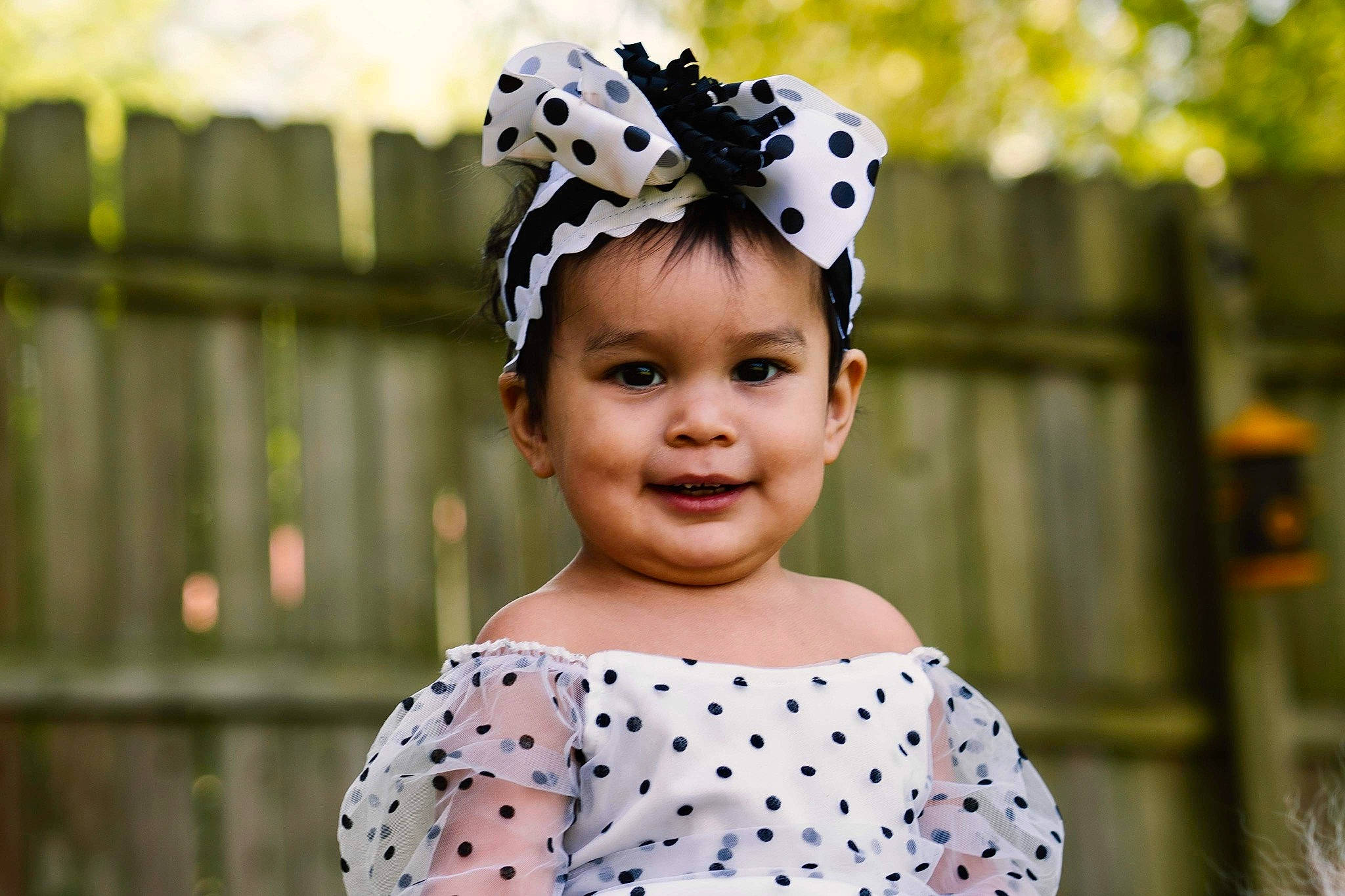Laila joined the competition — help win amazing prizes! baby_toddler_clothing, child, costume_hat, event, fashion_accessory, fence, fun, grass, hair_accessory, happy, headband, headpiece, jewellery, joy, pattern, person, plant, portrait_photography, sleeve, smile