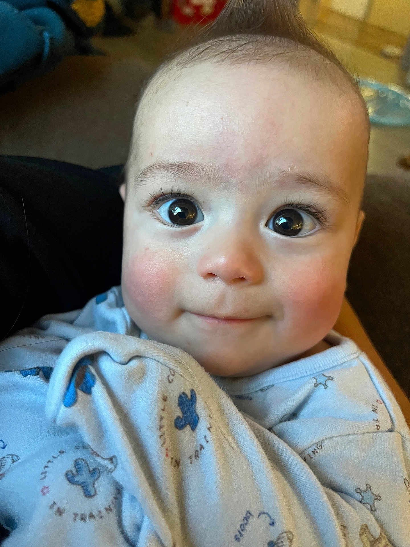 Arlus joined the competition — help win amazing prizes! baby, infant, face, eyes, rosy_cheeks, blanket, blue_clothing, close_up, cute, portrait, indoors, soft_lighting, child, young, expression, curious, wrapped, cozy, smile, skin