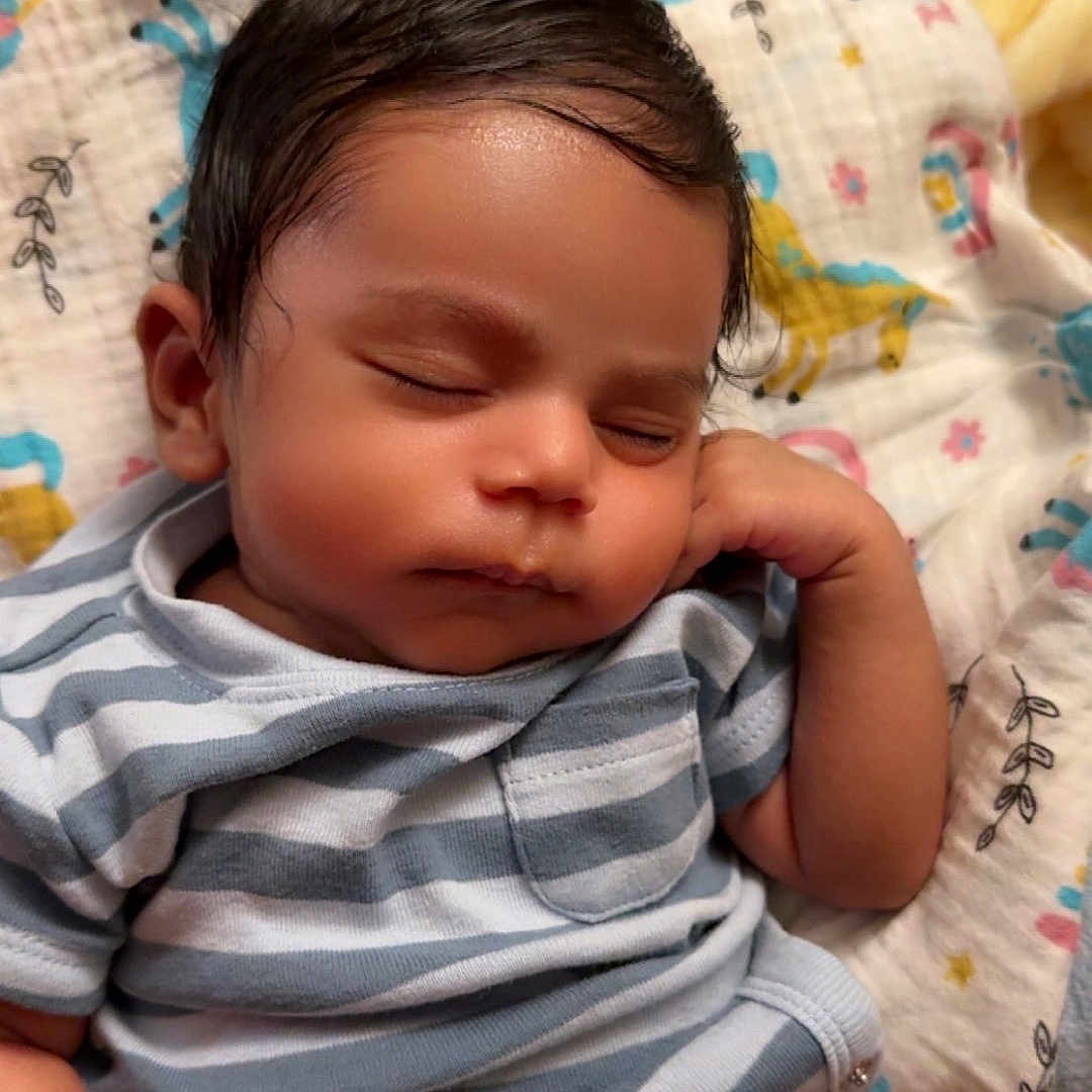 Vikranth joined the competition — help win amazing prizes! baby, blanket, child, closeup, comfort, cute, diaper, face, hand, indoors, infant, newborn, peaceful, portrait, relaxed, resting, sleeping, soft_lighting, striped_shirt, toddler