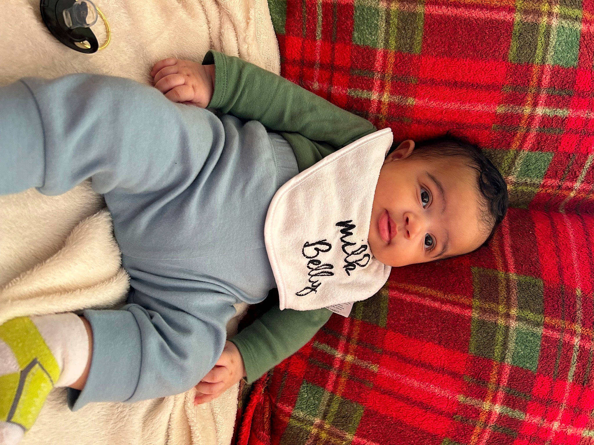 Zamari joined the competition — help win amazing prizes! baby, baby_toddler_clothing, child, comfort, elbow, gesture, head, linens, mammal, pattern, person, plaid, red, skin, sleeve, tartan, textile, toddler, vertebrate, wood