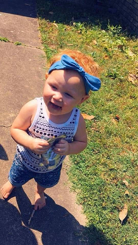 Chole is registered to the contest to win money with this photo: child, cool, fun, grass, happy, headgear, person, plant, play, smile, soil, toddler