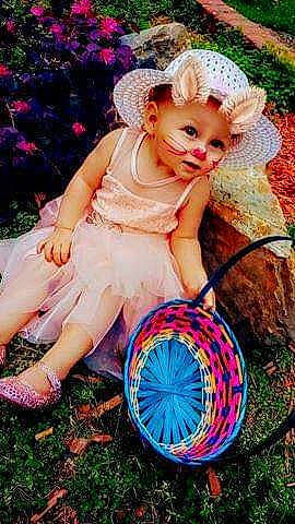 Chole is registered to the contest to win money with this photo: child_model, costume, crochet, doll, dress, grass, hair_accessory, hat, headgear, person, photography, plant