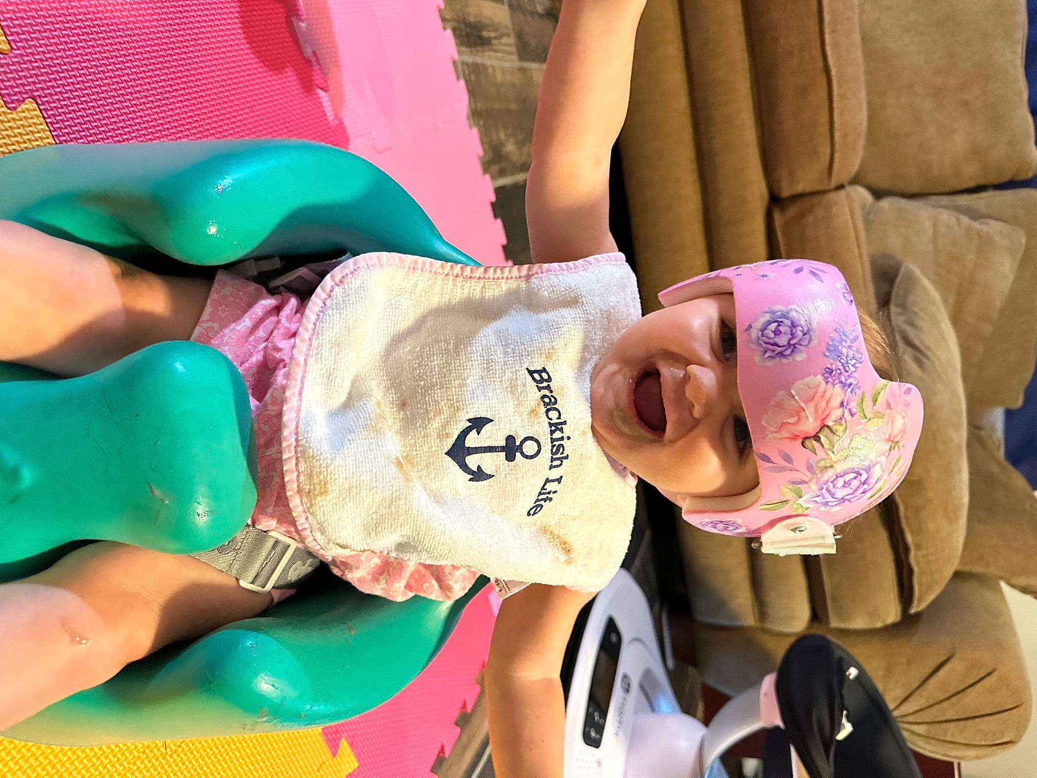 Taylor joined the competition — help win amazing prizes! baby, baby_toddler_clothing, child, comfort, couch, facial_expression, fashion_accessory, fun, green, happy, hat, headwear, leisure, person, pink, play, recreation, sitting, smile, thigh