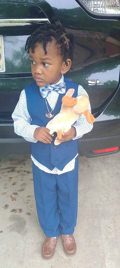 Bryce is registered to the contest to win money with this photo: auto_part, automotive_exterior, automotive_lighting, bumper, car, child, electric_blue, face, family_car, finger, formal_wear, gesture, person, sleeve, street_fashion, television, thumb, tie, toddler, trunk