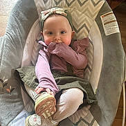 Eleanor joined the competition — help win amazing prizes! baby, child, infant, seat, baby_seat, headband, bow, purple_clothing, green_skirt, white_tights, sneakers, footwear, indoor, wooden_floor, candid, cute, smiling, playful, comfort, portrait