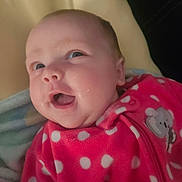 Eleanor joined the competition — help win amazing prizes! baby, infant, smile, pink_clothing, polka_dots, face, happy, blanket, cozy, child, apparel, cute, portrait, closeup, young_child, indoor, person, soft_texture, baby_girl, expression