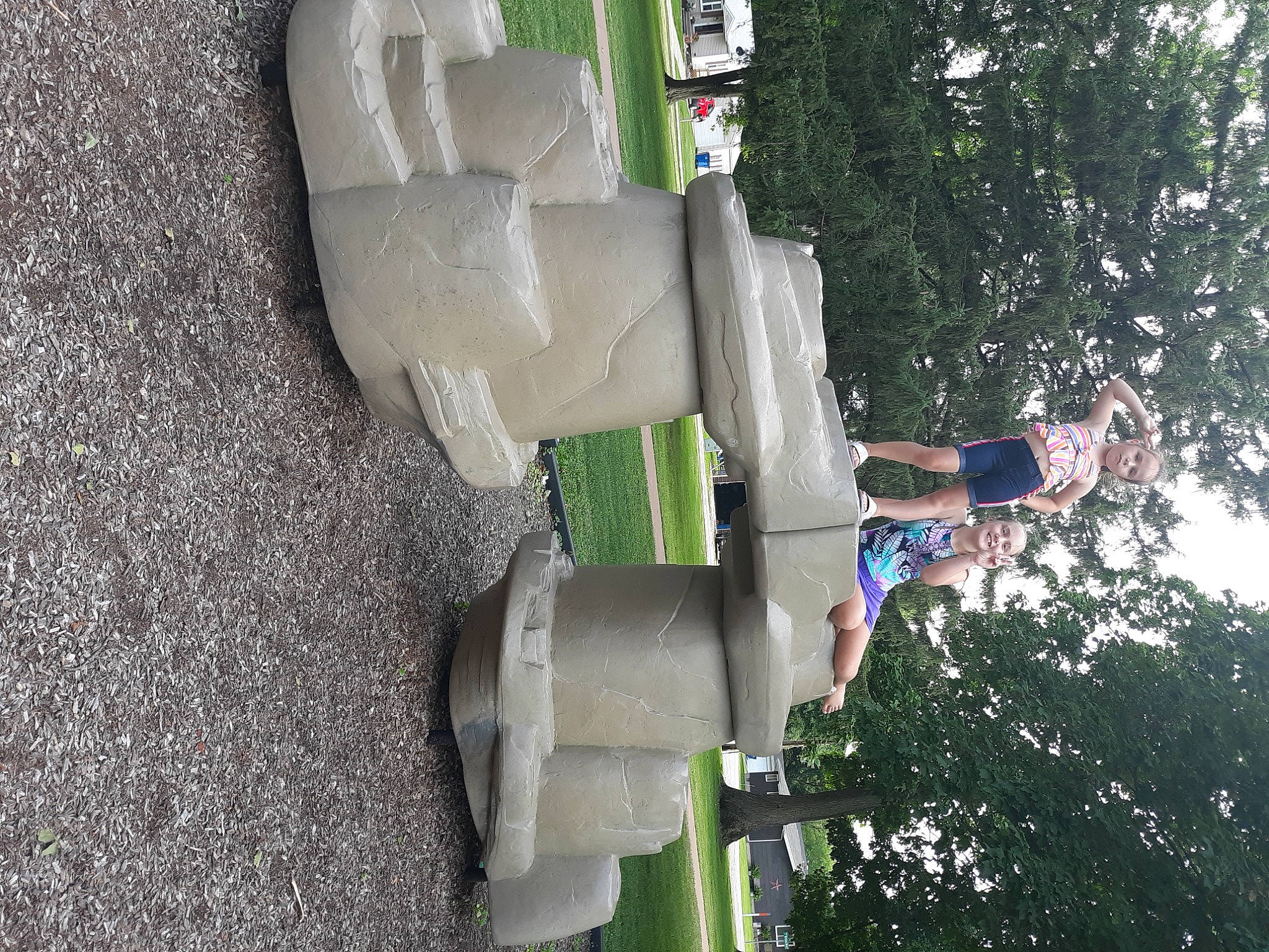 Sophia is registered to the contest to win money with this photo: art, concrete, elbow, fun, grass, joy, leisure, machine, person, plant, pole, recreation, sculpture, sky, statue, tire, tree, wheel, window