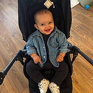 Ethan participe au concours pour gagner de l'argent avec cette photo : baby, smile, denim_jacket, black_outfit, stroller, wooden_floor, indoor, child, footwear, white_shoes, happy, sitting, cute, infant, person, casual_clothing, small_child, baby_shoes, cheerful, portrait