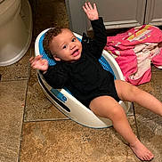 Samiyah joined the competition — help win amazing prizes! baby, child, infant, smiling, waving, sitting, reclining, black_clothing, curly_hair, barefoot, baby_seat, bathroom, tile_floor, pink_blanket, indoor, portrait, happy, face, arms_raised, home