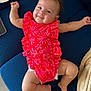 Alba a rejoint le concours — aidez-le/la à gagner de superbes lots ! baby, infant, smile, red_clothing, floral_pattern, cushion, blue, lying_down, happy, skin, barefoot, cheeks, arms, legs, diaper, indoors, texture, closeup, cute, portrait