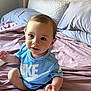 Izayah joined the competition — help win amazing prizes! toddler, child, baby, blue_shirt, nike, bed, pillow, blanket, indoors, curious, sitting, cute, person, head, face, skin, light, young, clothing, home