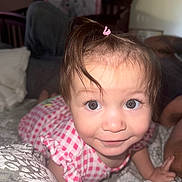 Lilliana joined the competition — help win amazing prizes! toddler, child, baby, crawling, pink_dress, hair_tie, bedroom, blanket, bed, person, face, eyes, smile, curious, indoors, closeup, furniture, soft_lighting, cute, young_child