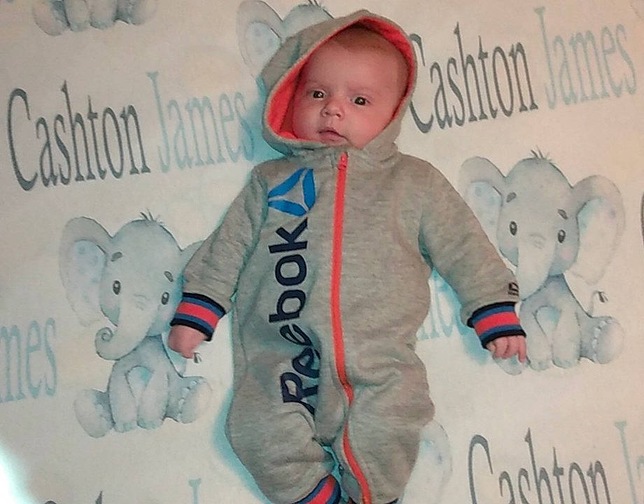 Cashton is registered to the contest to win money with this photo: baby, baby_products, baby_toddler_clothing, child, electric_blue, font, fur, gesture, glove, happy, linens, mammal, pattern, person, personal_protective_equipment, pink, sleeve, t_shirt, textile, toddler