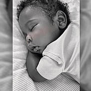 Nore joined the competition — help win amazing prizes! baby, sleeping, curly_hair, blanket, striped, black_and_white, infant, peaceful, soft_lighting, portrait, closeup, child, resting, cute, toddler, face, clothing, bed, indoors, calm
