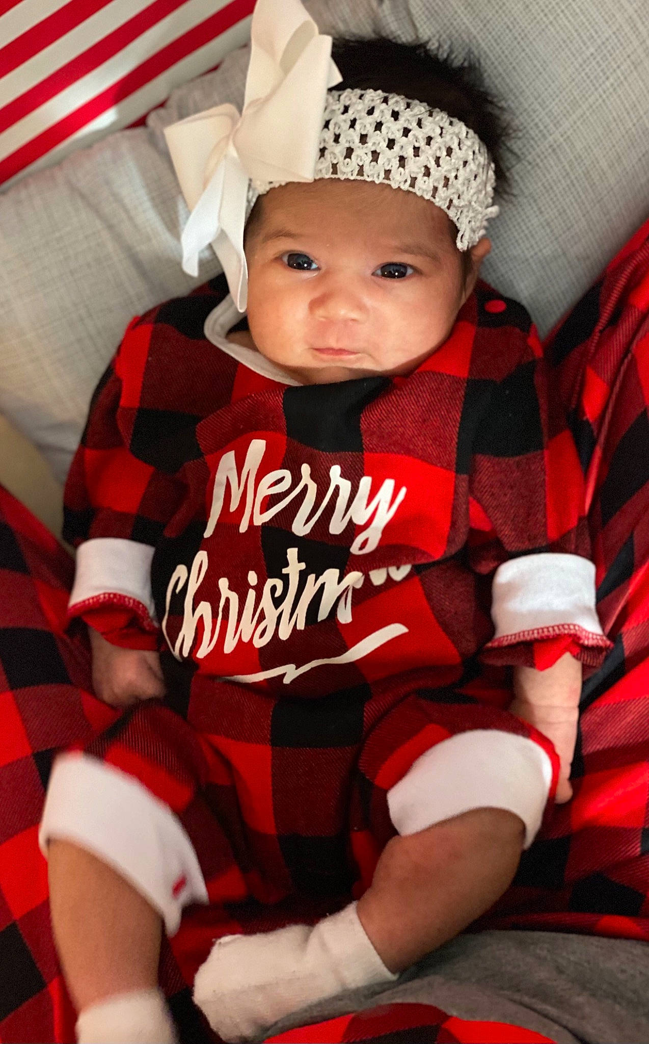 Abriella joined the competition — help win amazing prizes! baby, baby_products, baby_toddler_clothing, bonnet, carmine, child, child_model, comfort, costume_accessory, headwear, lap, linens, mouth, pattern, person, plaid, red, sleeve, sock, tartan